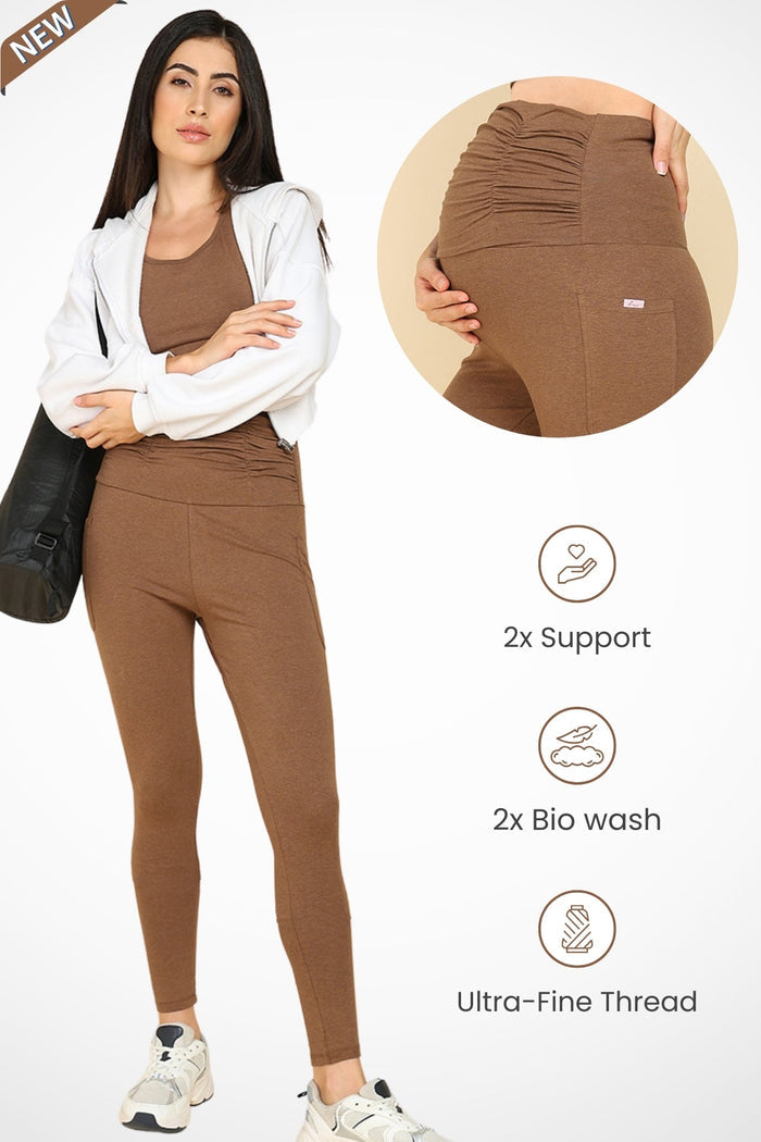 Model wearing Brown Ruched Legging; ruched maternity panel stretches over the pregnant bump.