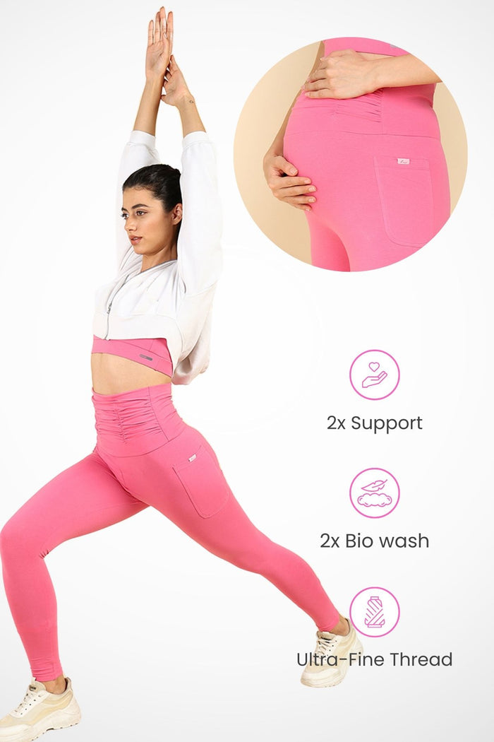 Model wearing Pink Ruched Legging; ruched maternity panel stretches over the pregnant bump.