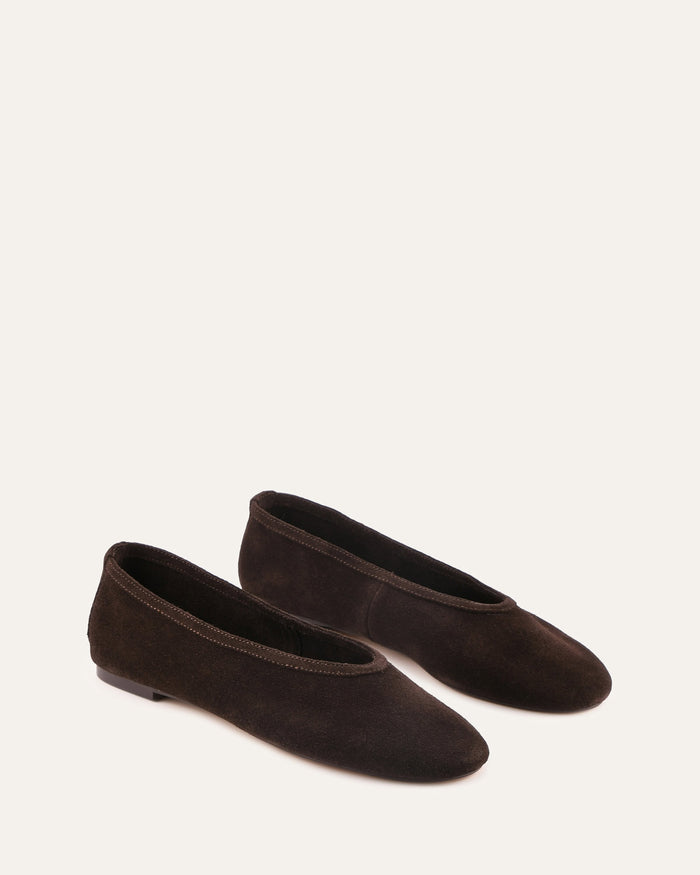 Pair of brown suede shoes on a white background