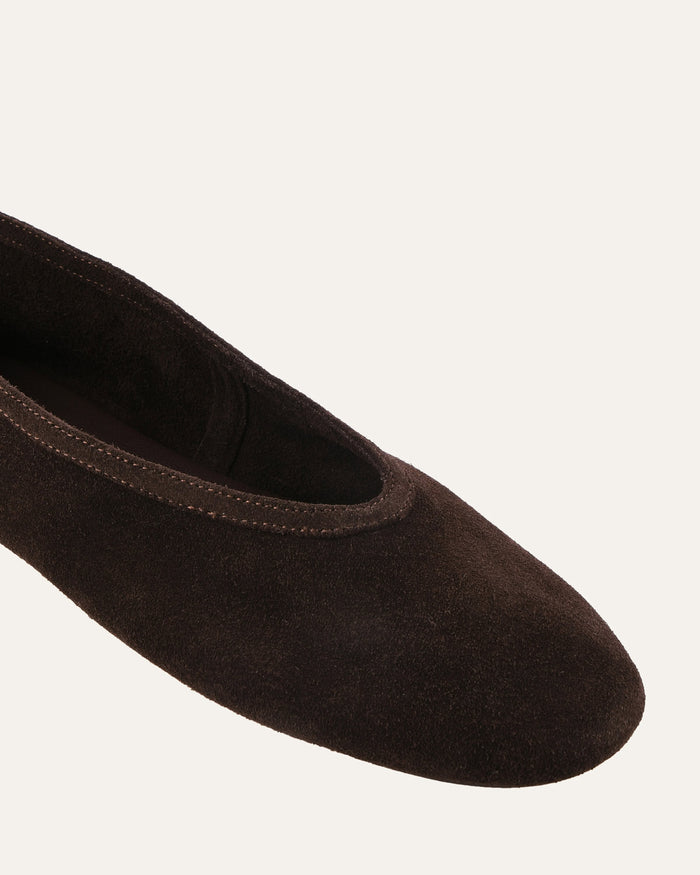 Brown ballet flat shoe on a white background