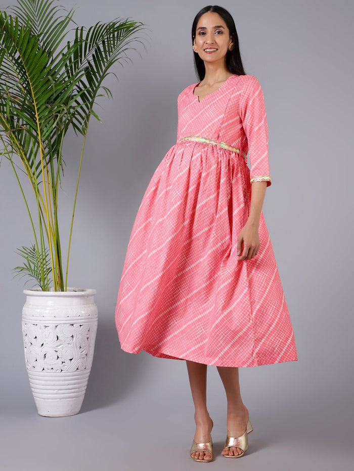Woman wearing Salmon Splash Maternity Dress with Embroidered Lace and Pocket in Red - Pre & Post Pregnancy