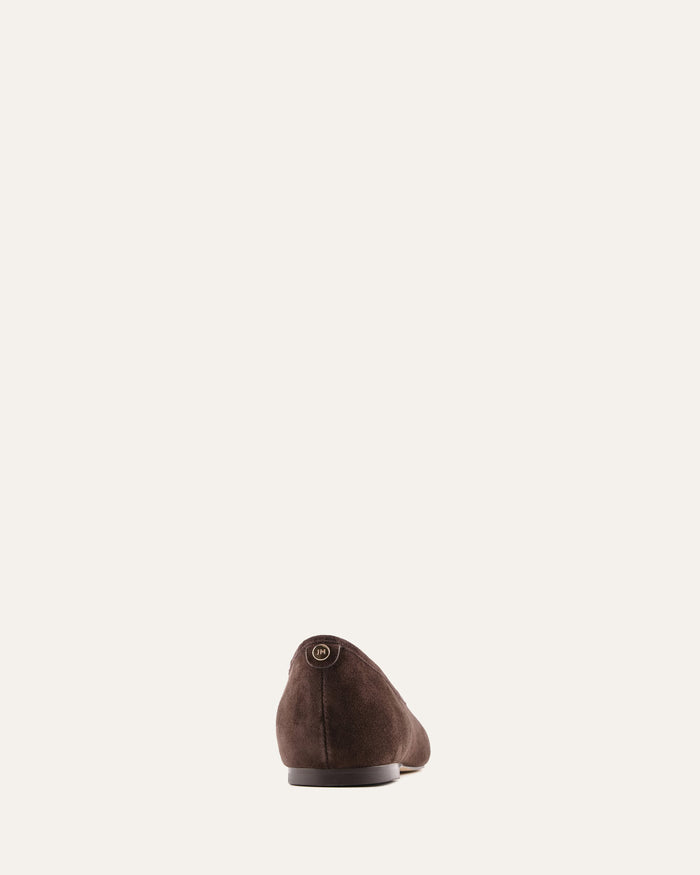 Brown suede shoe on a light beige background