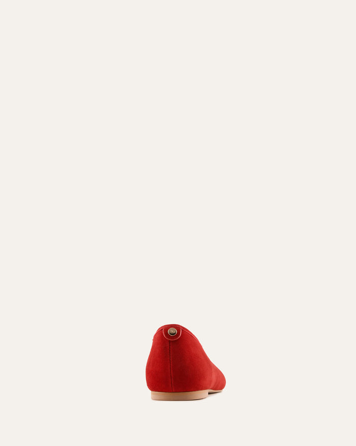 Red shoe on a light beige background