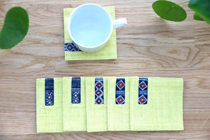 White cup placed on yellow hemp coaster with indigo accent