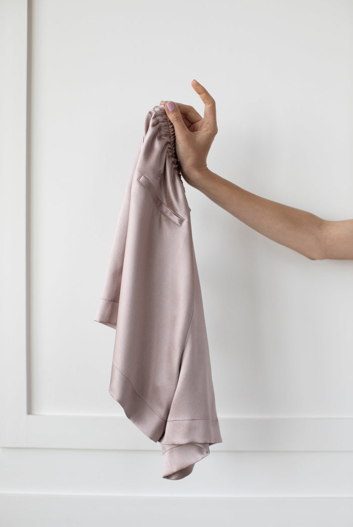 Signature Edit Pink Lounge Shorts held loosely by the waistband.