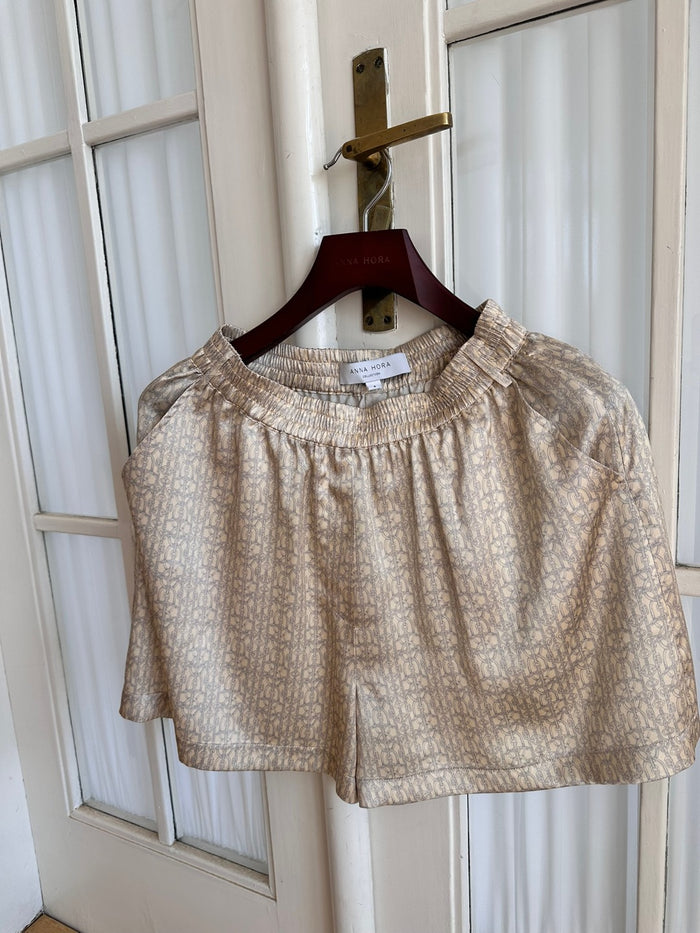 Silk Edit Chain Print Lounge Shorts hanging on a hanger, front view.