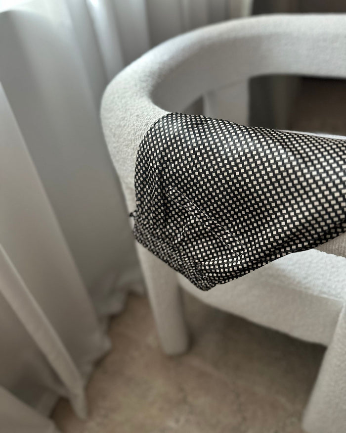 Silk Edit Geometric Lounge Shorts draped over a boucle chair.