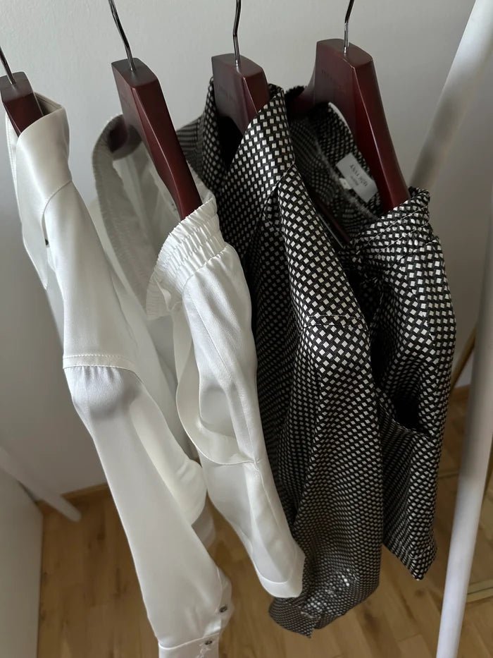 Silk Edit Geometric Lounge Shorts hanging on a rail with other styles.