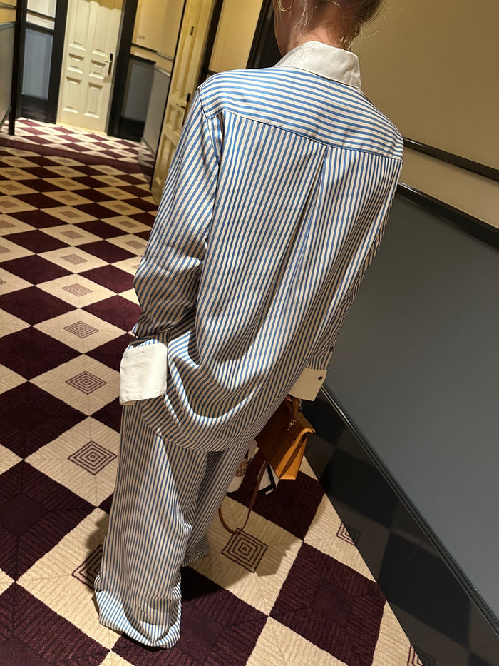 TENCEL™ Edit Blue Stripe Lounge Shirt back view on a checkered floor.