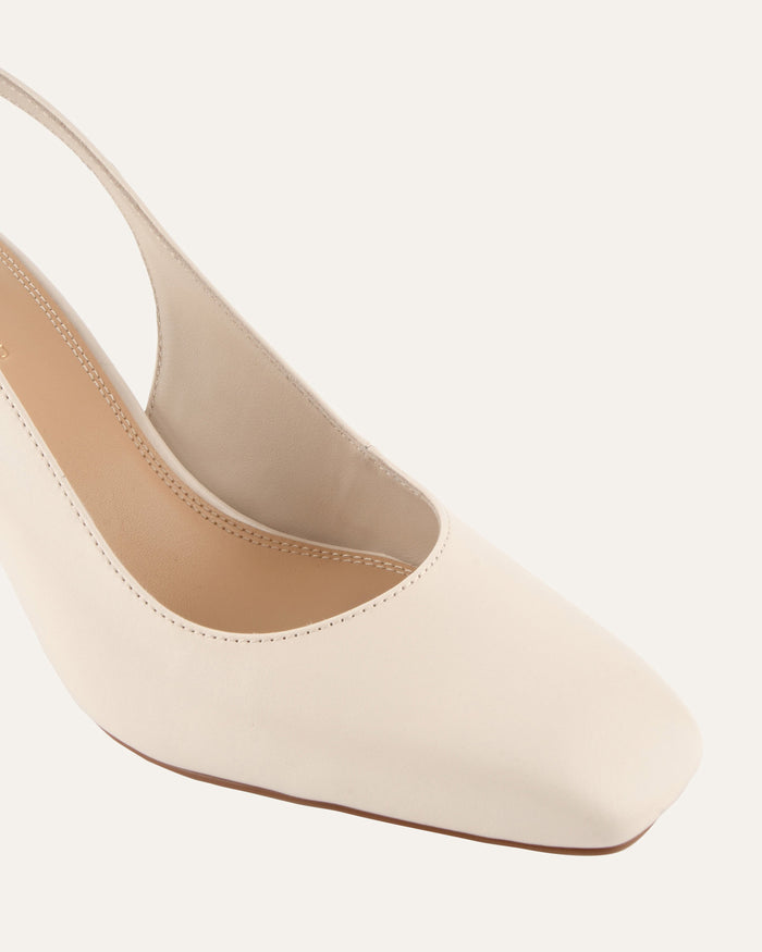 Beige high-heeled shoe on a white background