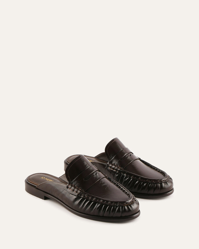 Pair of brown leather slippers on a white background