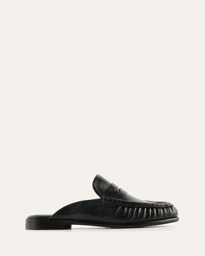 Black loafer shoe on a light gray background