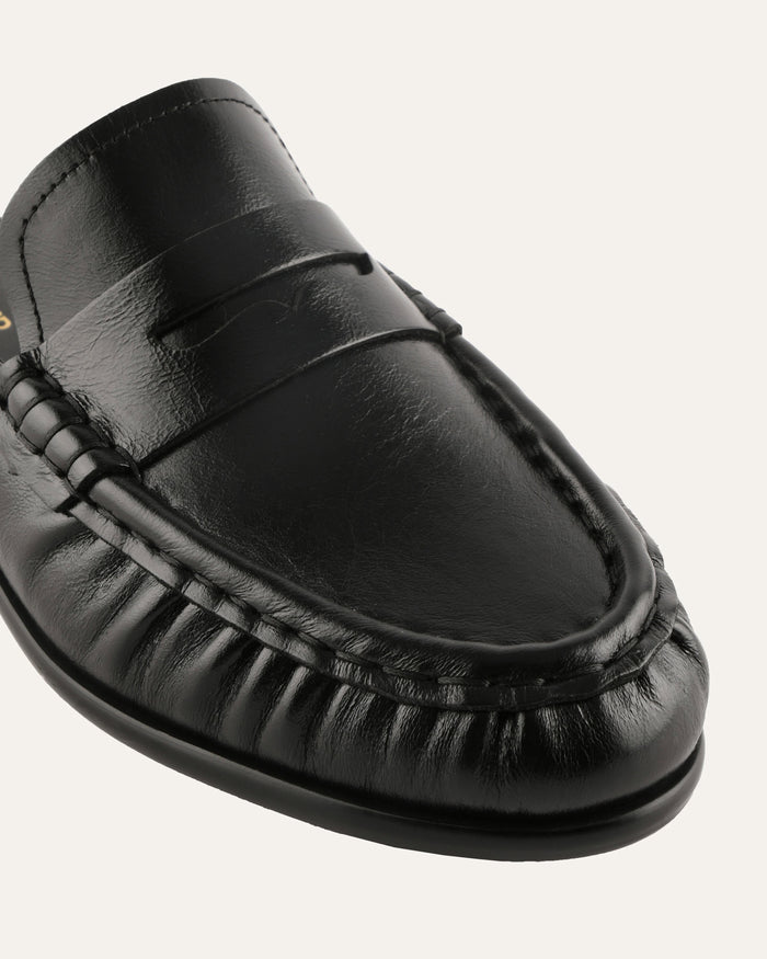 Black leather loafer shoe on a white background