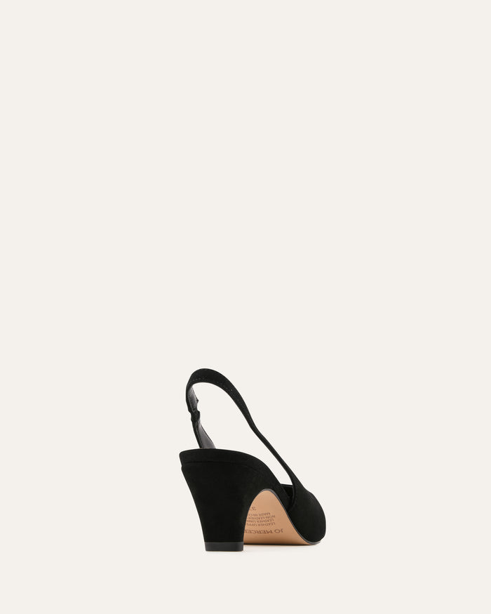 Black wedge sandal on a beige background