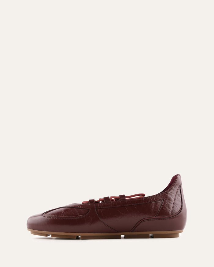 Maroon leather shoe on a white background