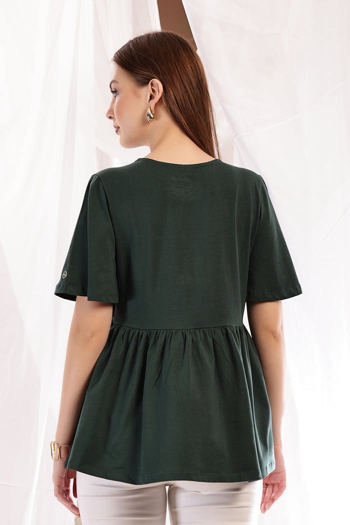 Side view of Bottle Green Top; ensures proper fit and room for pregnancy growth.