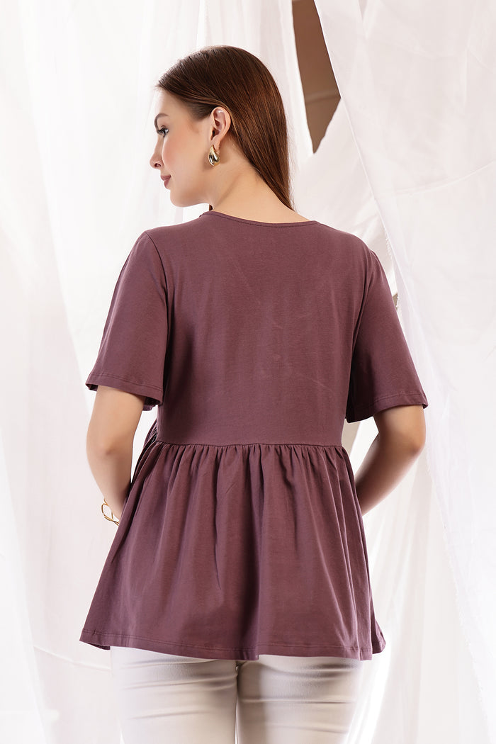 Detail shot of Cotton fabric; shows stretch and rosewood color/print.