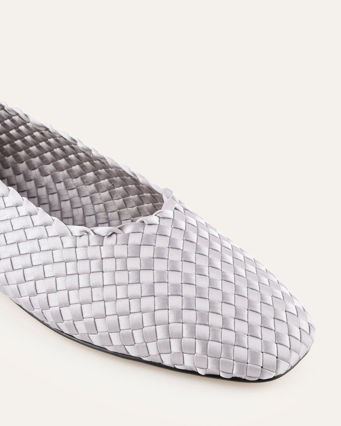 Woven patterned flat shoe on a white background