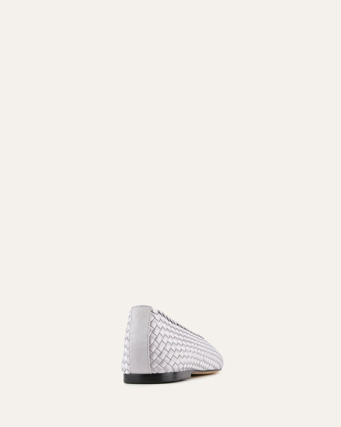 White woven shoe on a light beige background