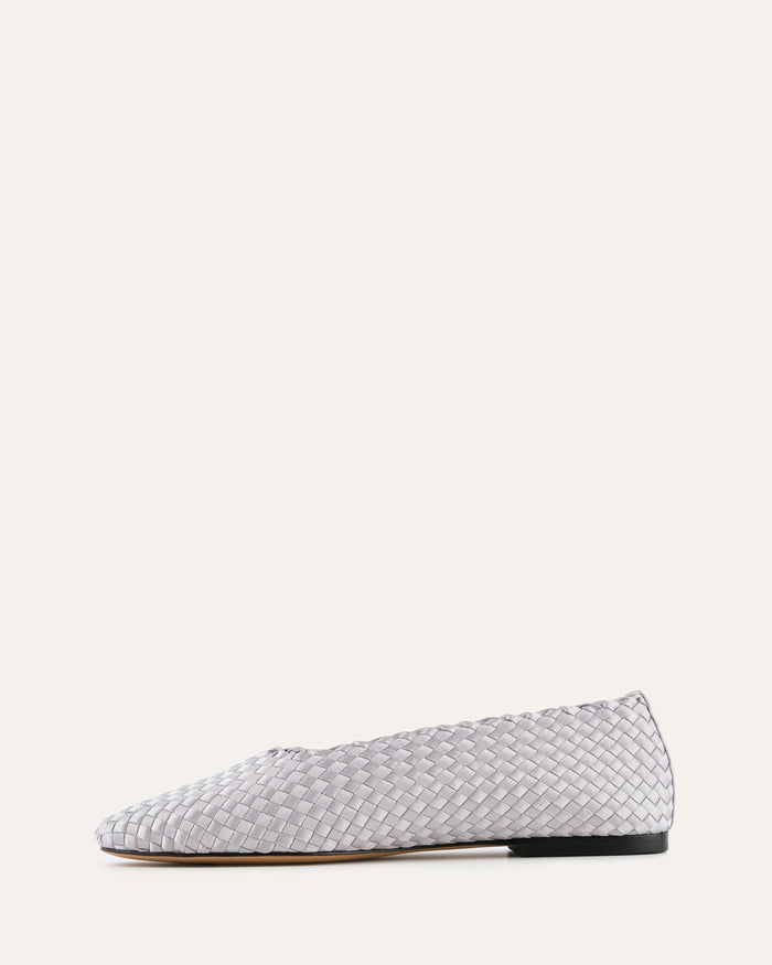 Woven patterned flat shoe on a white background