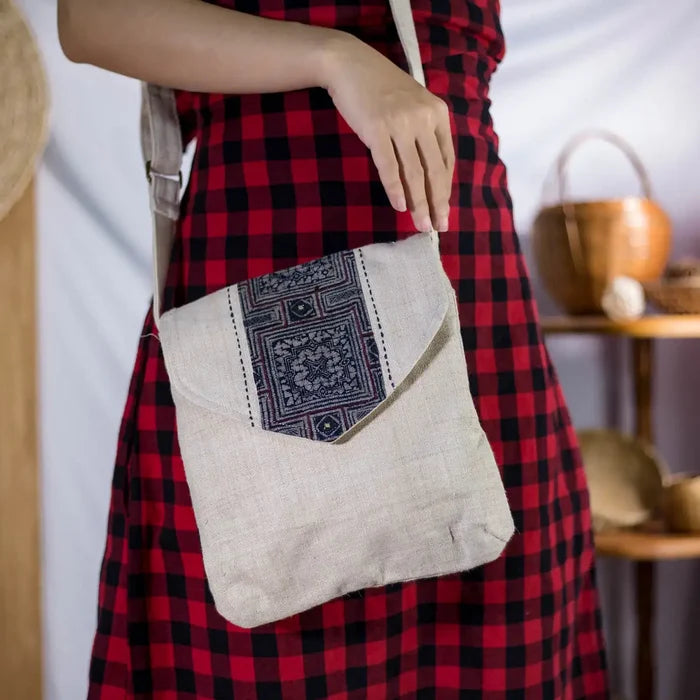 Handmade hemp handbag with bamboo handle and batik patch, side view on model