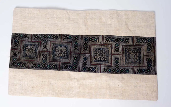 Front view of beige hemp cushion cover with indigo embroidery panel