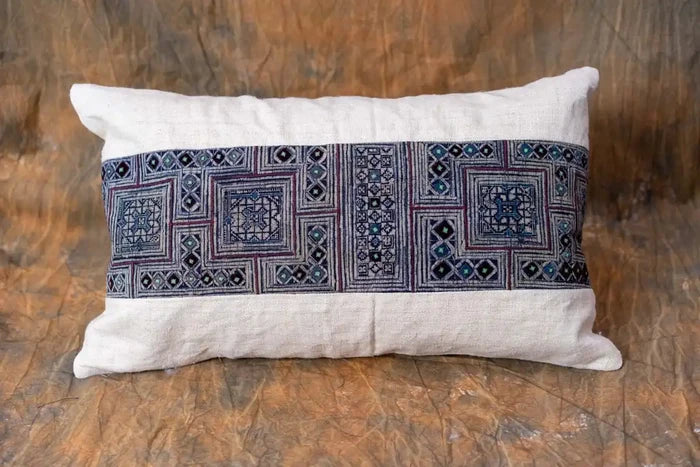 Vindigo beige hemp lumbar cushion with indigo embroidery on sofa