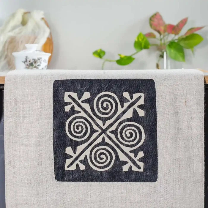 Vindigo beige hemp table runner close-up showing hand-stitched black and white spiral motif