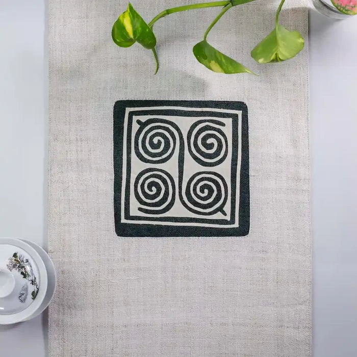 Vindigo beige hemp table runner center view highlighting traditional H’mong spiral