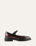 Black leather shoe with a strap on a white background