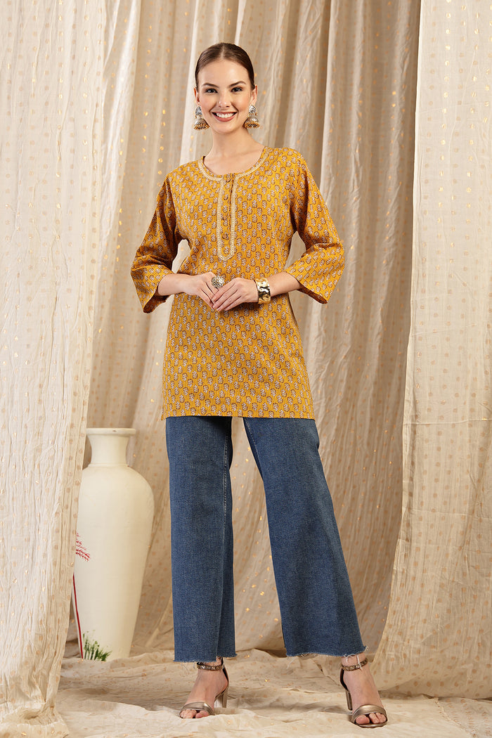 Ocher Booty Top detail; shows fit across the chest and shoulders.